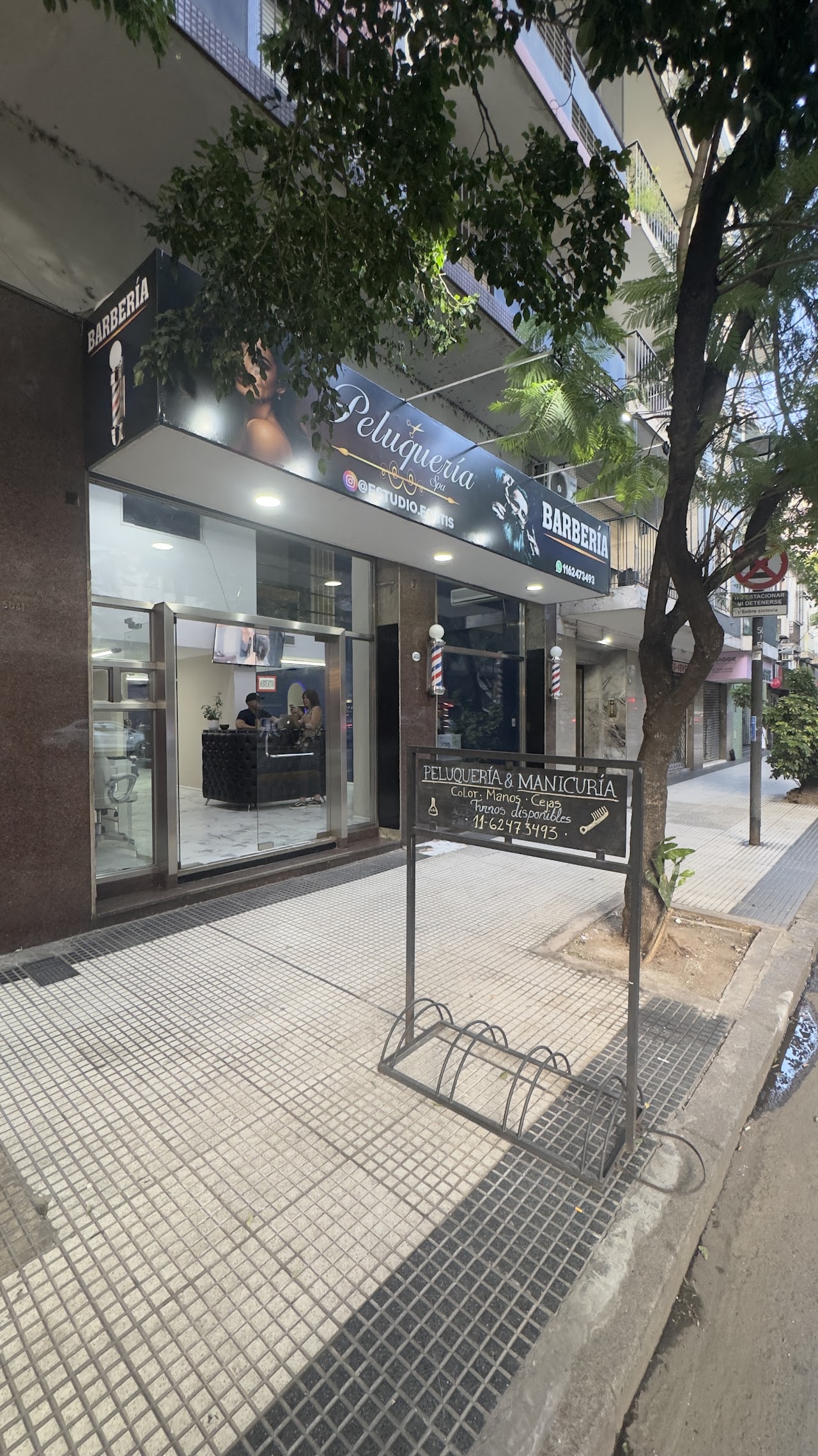 Interior of Fortis Barbería showing premium chairs and warm lighting